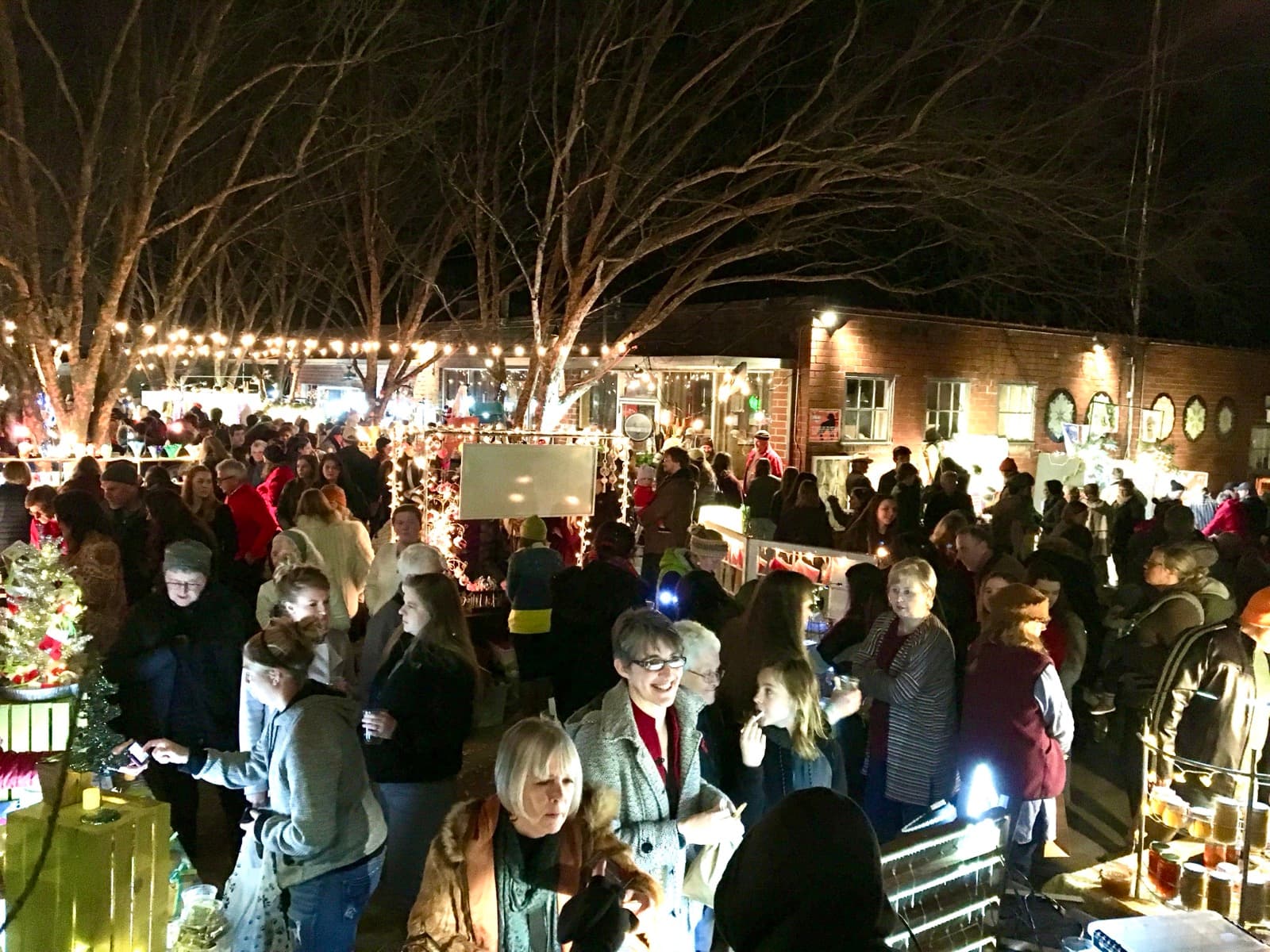 Shoppers browsing handmade goods in the Big City Bread courtyard at the Athens Holiday Market
